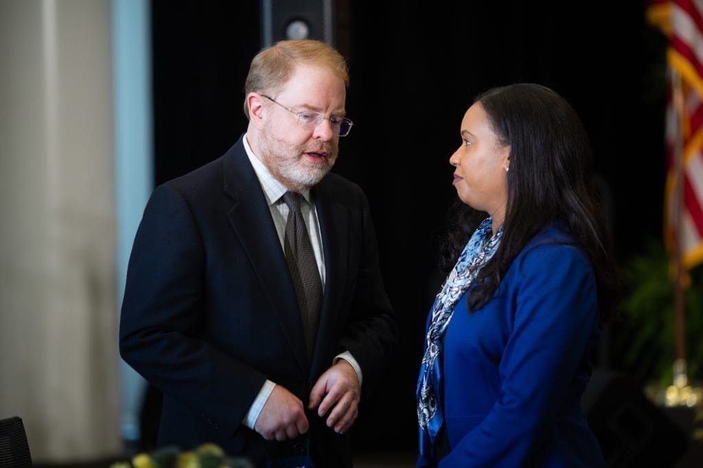 President Hans speaking with a university chancellor