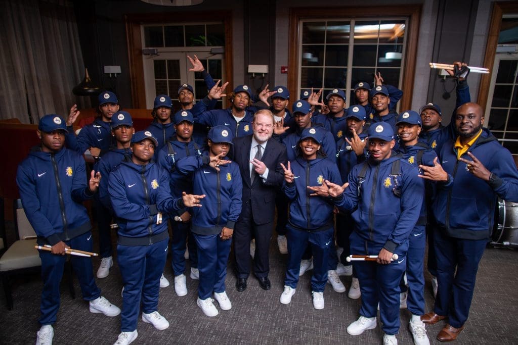 President Hans posing with a large group of student athletes
