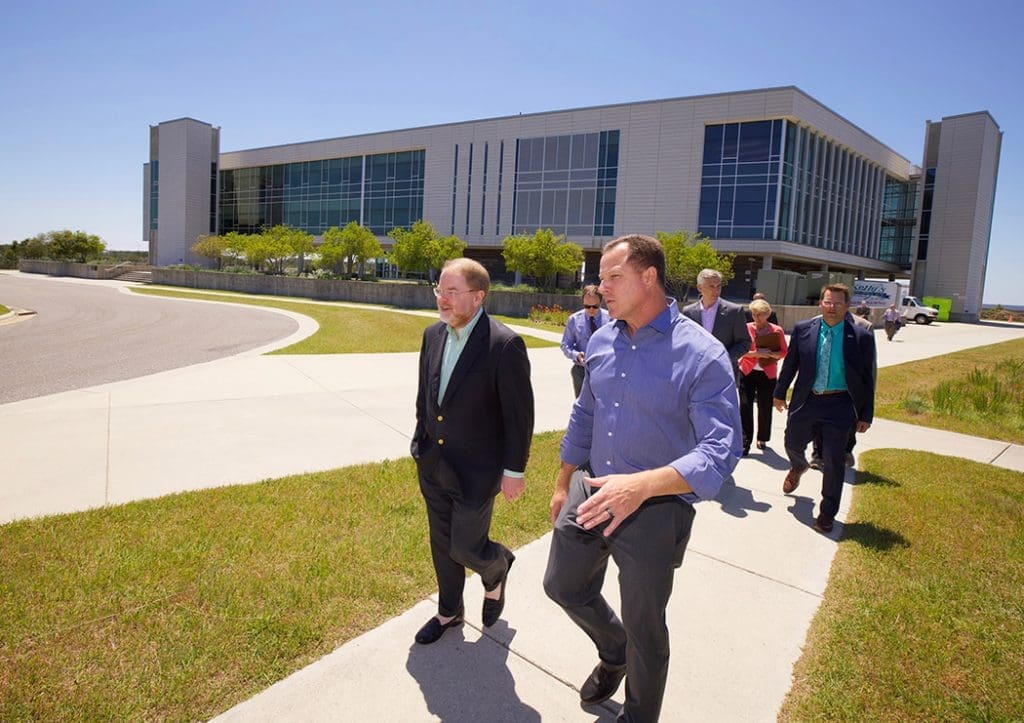 President Hans walking with a group people at ECU