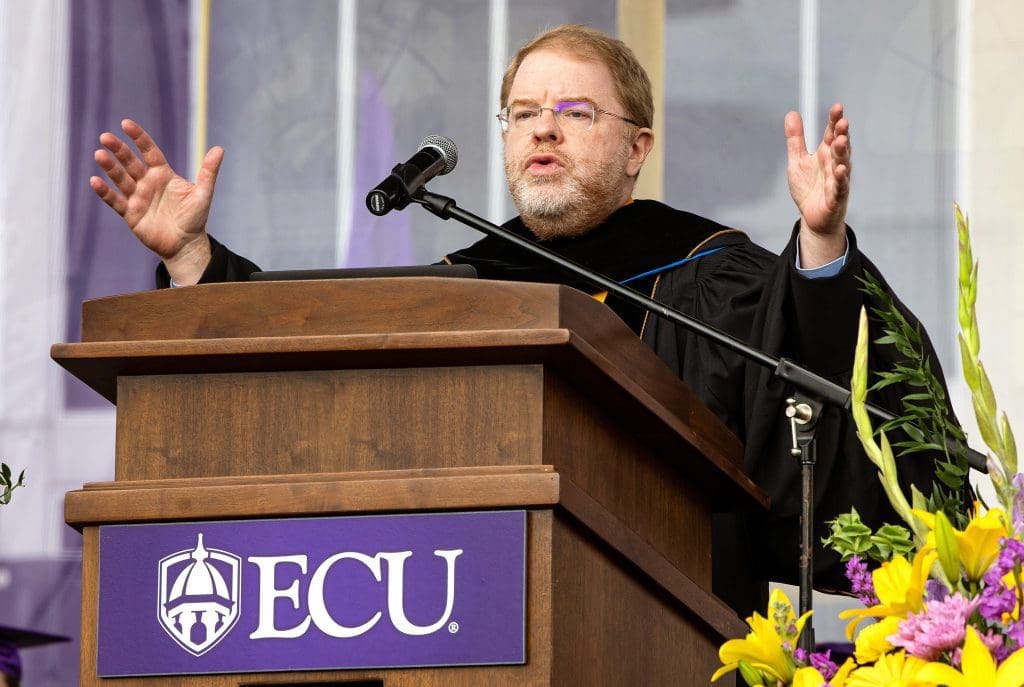 President Hans speaking at a podium at East Carolina University